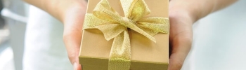 Gold gift box in hands